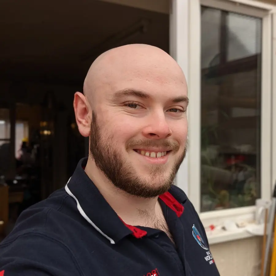 A picture of Owain smiling at the camera